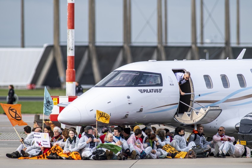 Activists block a private jet at Schiphol airport
